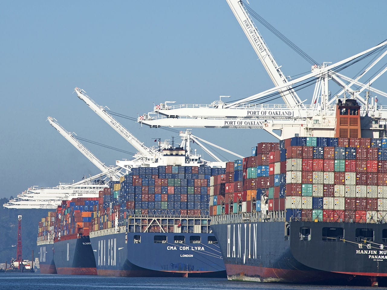 Container boats being unloaded at a US Port from China highlighting the escalating tariffs on imported Chinese goods